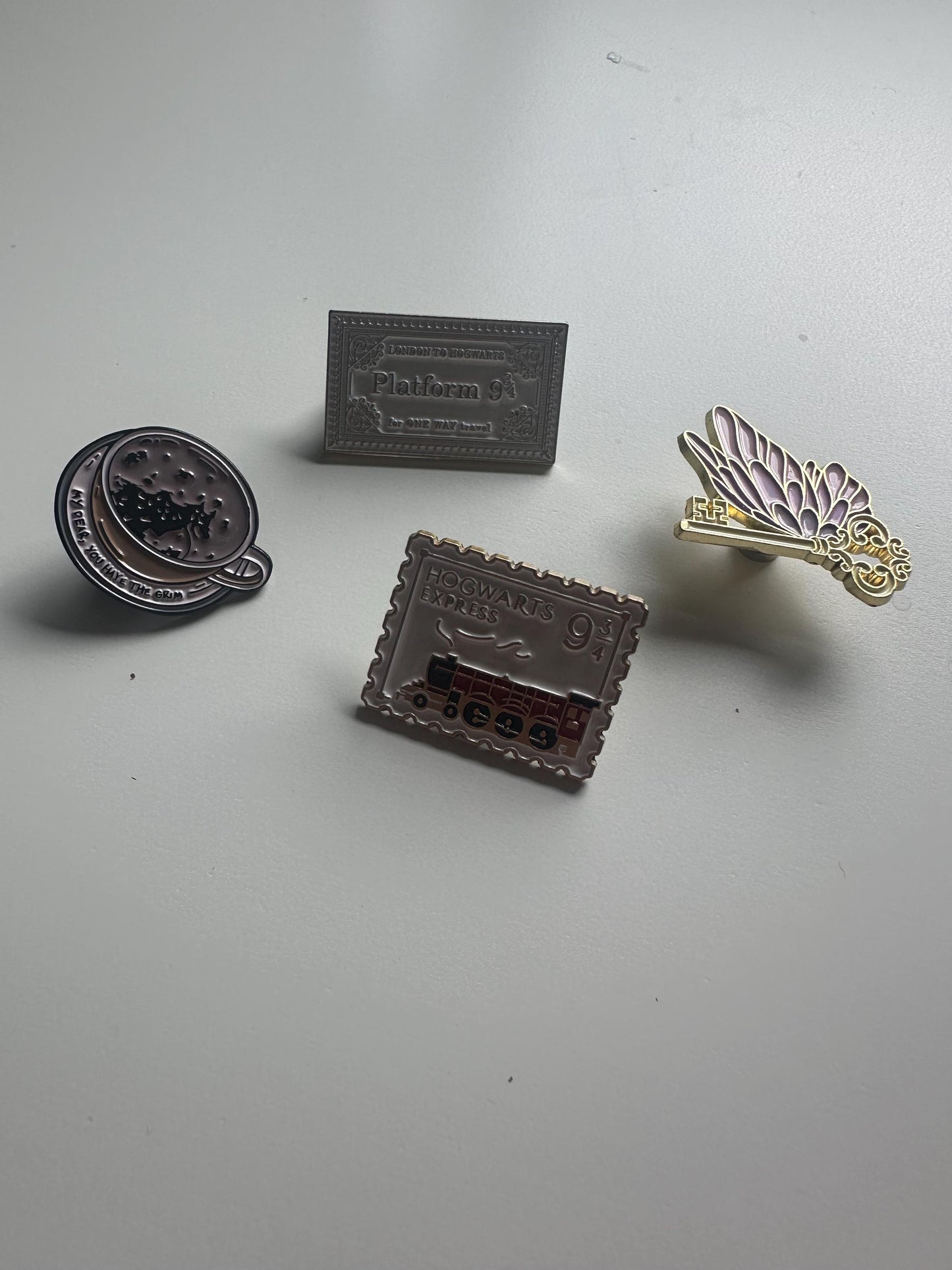 Wizarding pins - flying/winged key, train ticket, post stamp, grim teacup