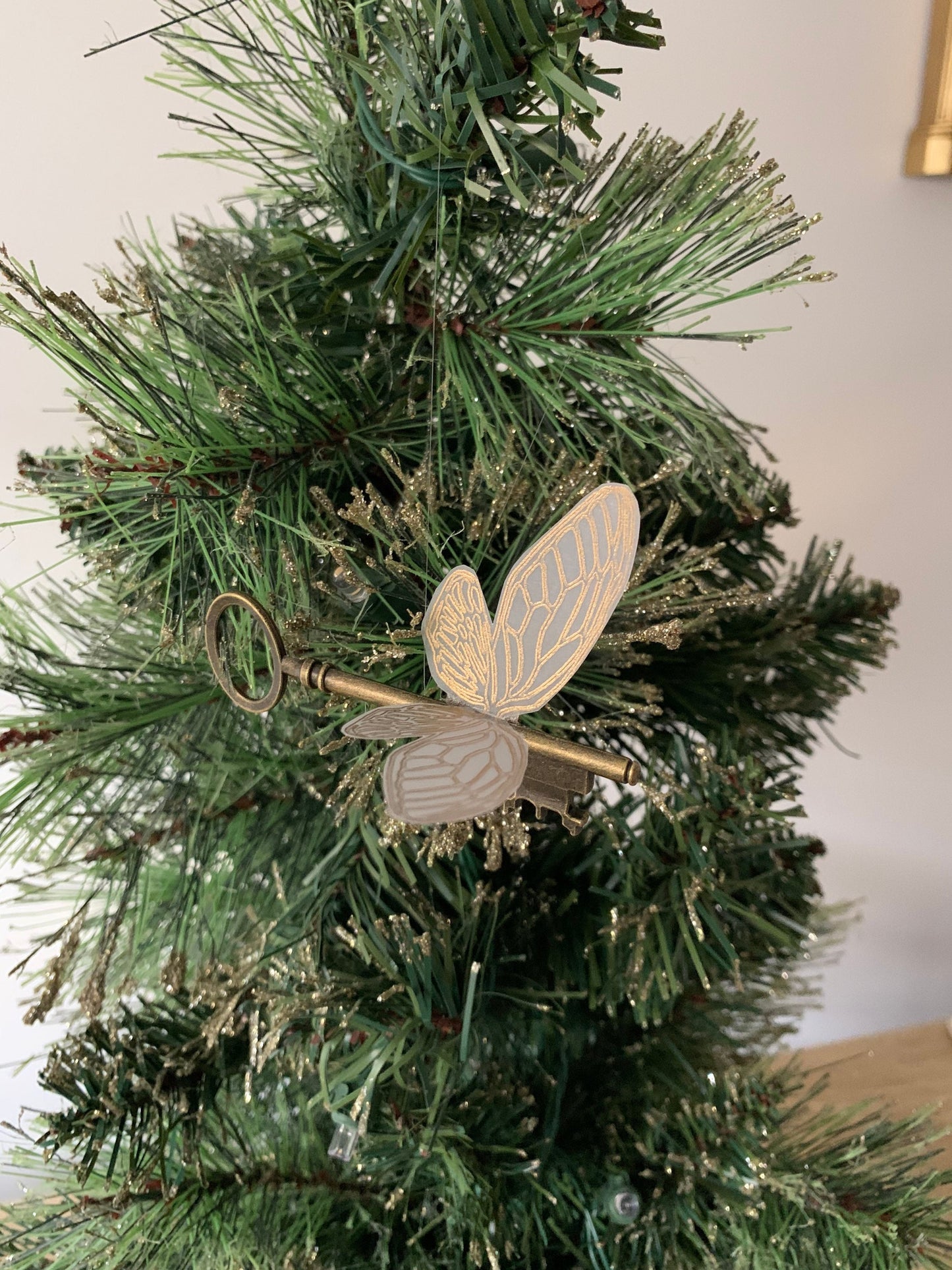 Flying key gold foiled Christmas ornament