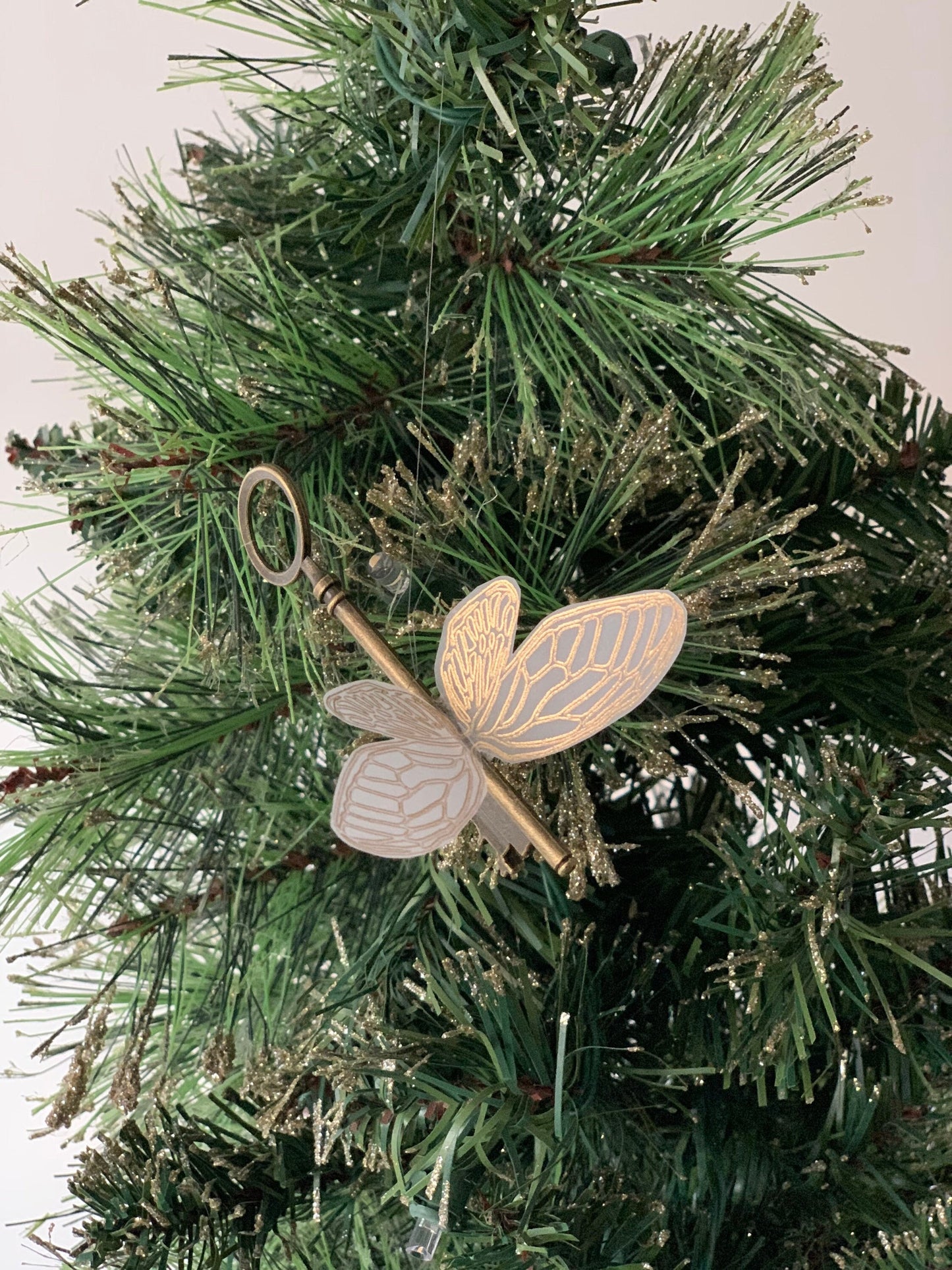 Flying key gold foiled Christmas ornament